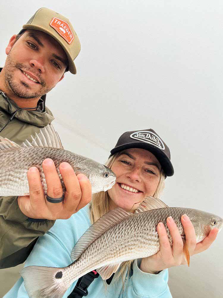 A smiling couple enjoys their time on a Saltwater Fishing Charters trip, capturing the joy of the experience. The image underscores the enjoyable and inviting nature of Saltwater Fishing Charters, aligning with the website's focus on offering memorable fishing adventures and comprehensive service details.