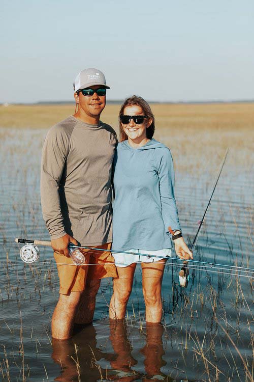 A smiling couple enjoys their time on a Saltwater Fishing Charters trip, capturing the joy of the experience. The image underscores the enjoyable and inviting nature of Saltwater Fishing Charters, aligning with the website's focus on offering memorable fishing adventures and comprehensive service details.