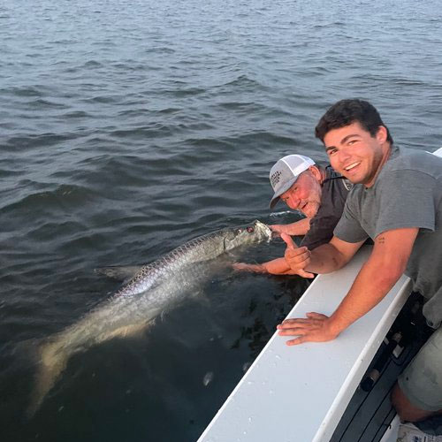 Image of men holding fish, featuring Saltwater Fishing Charters and highlighting TARPON, showcasing the thrill and success of their fishing adventures.