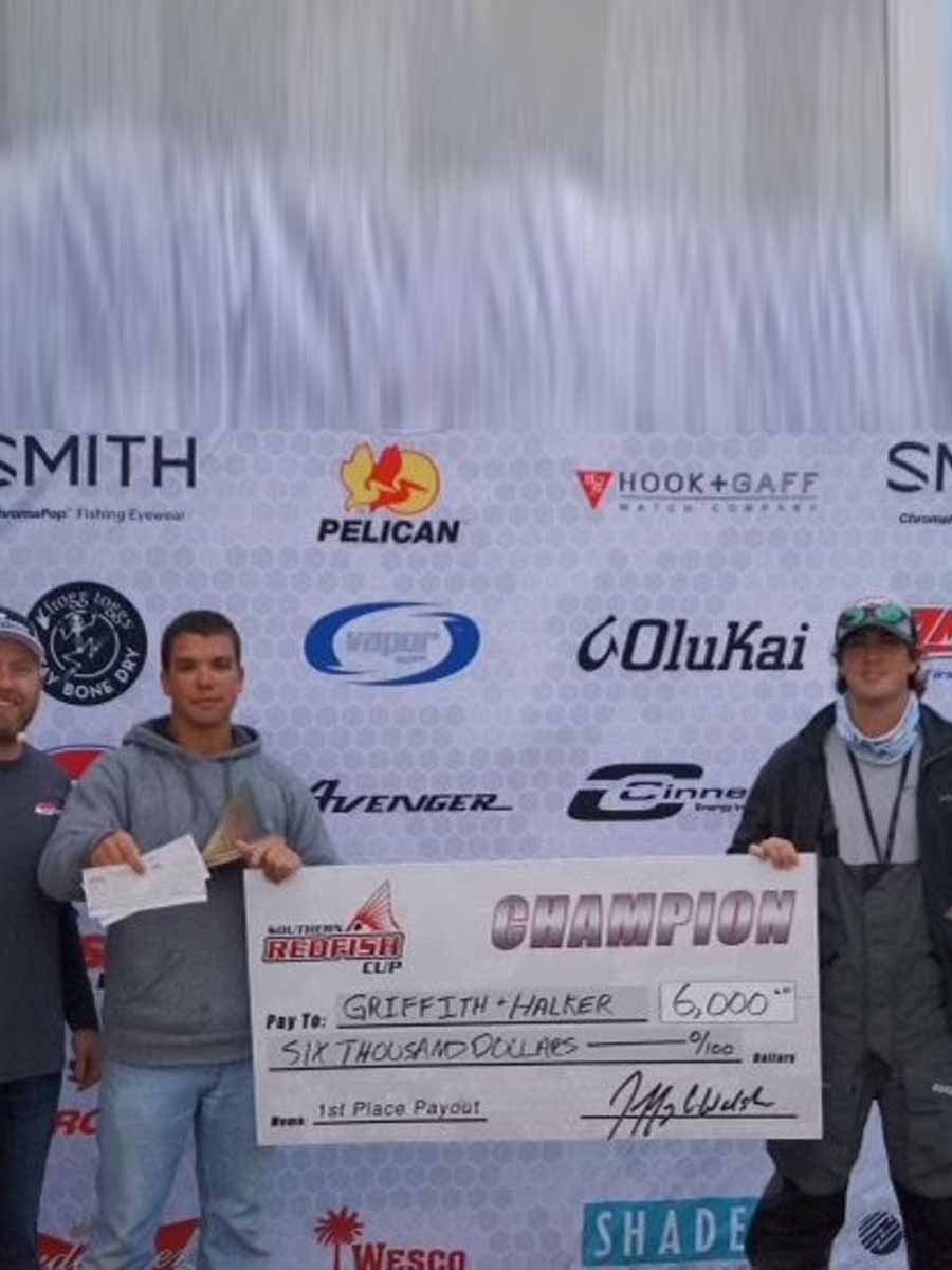 Two men proudly display an award they received from Saltwater Fishing Charters, celebrating their achievement. The image highlights the recognition and success associated with Saltwater Fishing Charters, aligning with the website's focus on showcasing its premier fishing services and accomplishments.