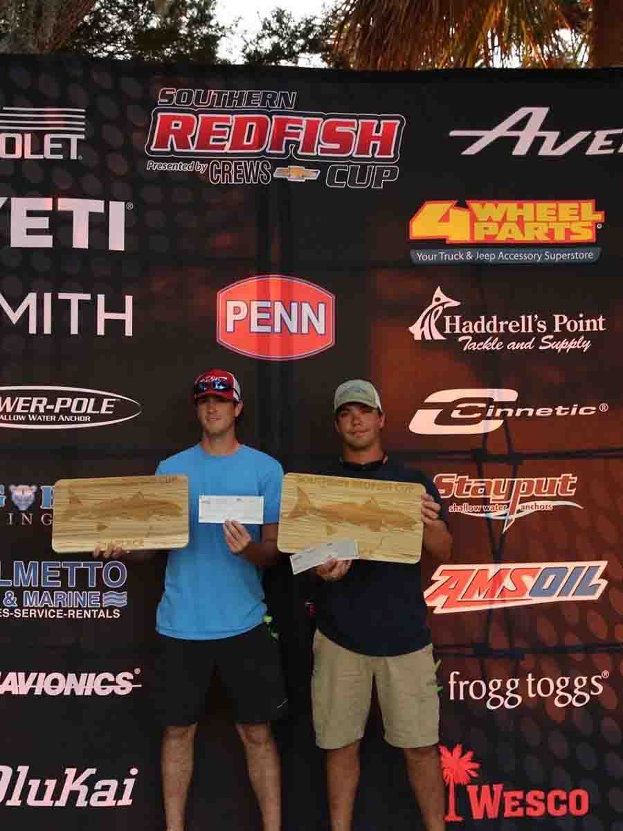 Two men proudly display an award they received from Saltwater Fishing Charters, celebrating their achievement. The image highlights the recognition and success associated with Saltwater Fishing Charters, aligning with the website's focus on showcasing its premier fishing services and accomplishments.