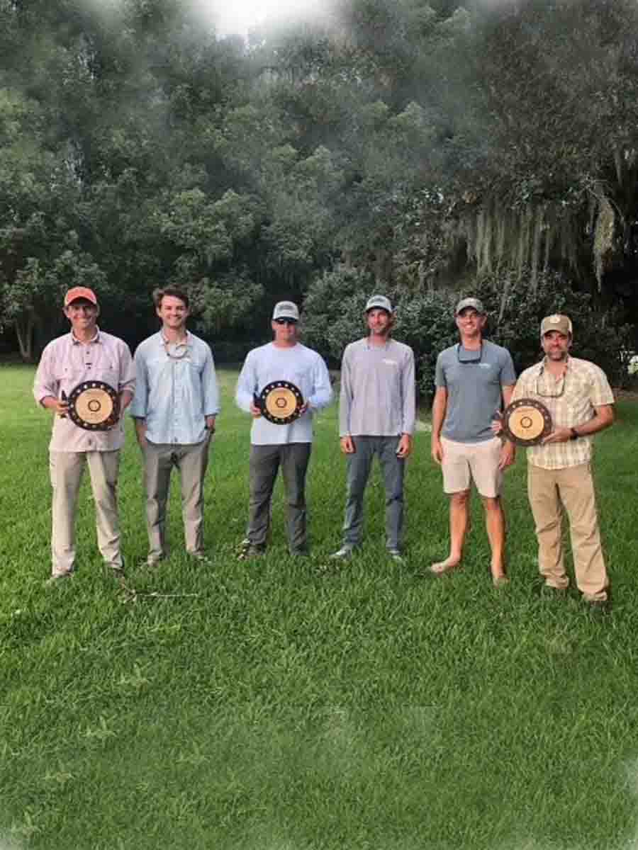 A group of people proudly displays an award they received from Saltwater Fishing Charters, celebrating their accomplishment. The image highlights the recognition and success associated with Saltwater Fishing Charters, aligning with the website's focus on showcasing its top-tier fishing services and achievements.