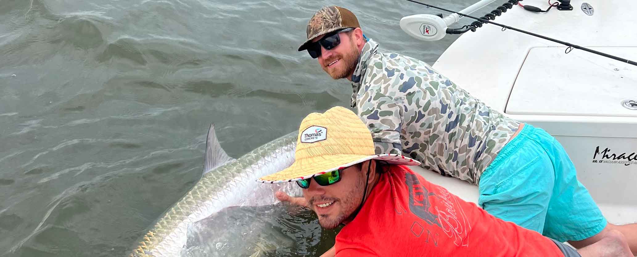 Image of men holding a fish, featuring Saltwater Fishing Charters and highlighting his catch, illustrating a successful fishing trip.